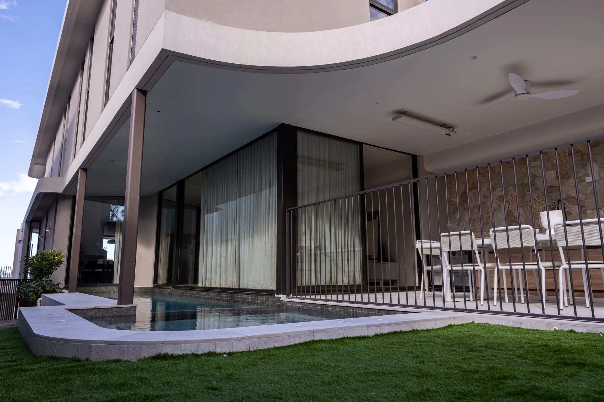Covered alfresco terrace and dining setting beside the pool
