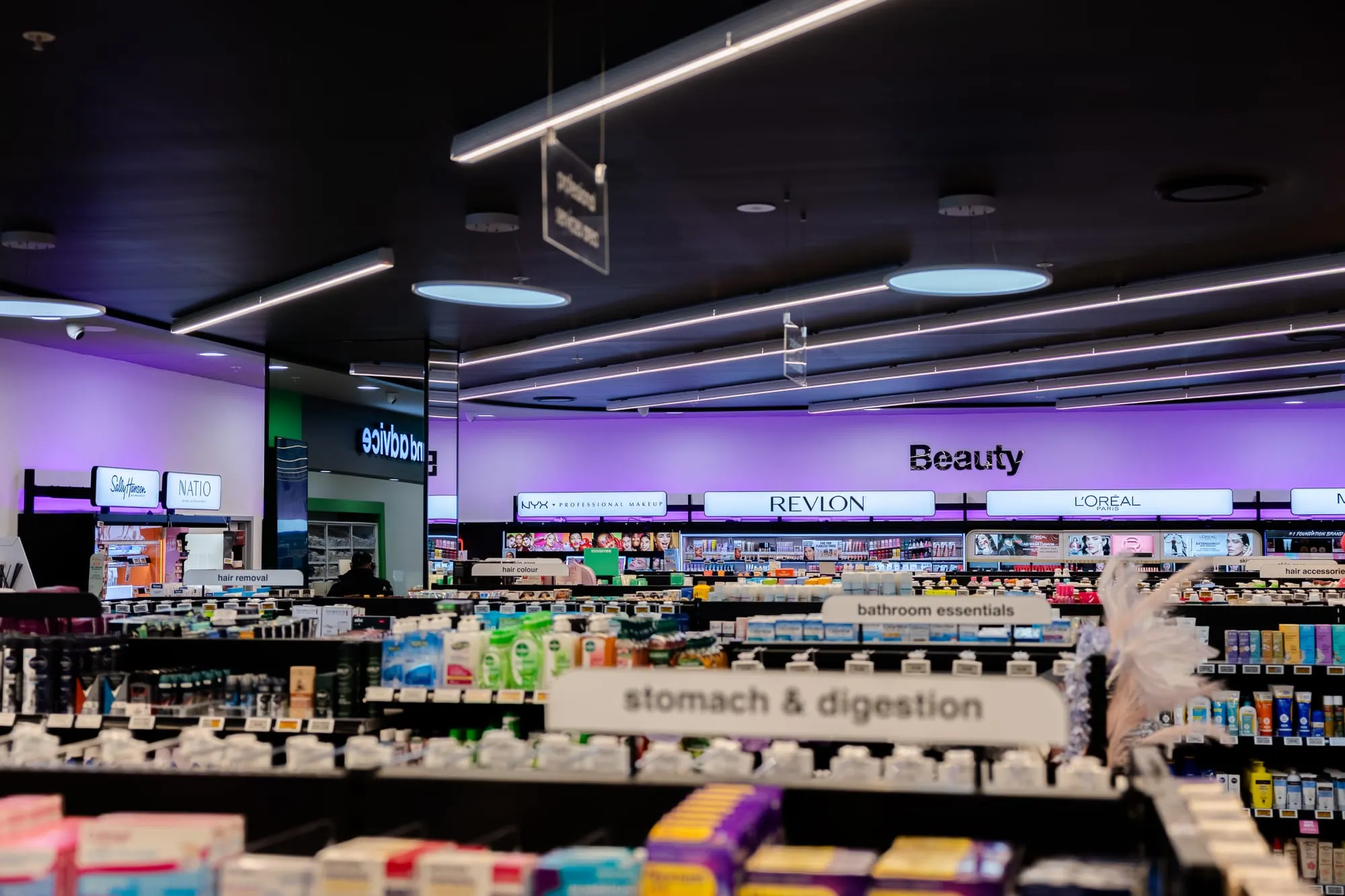 Cosmetics department with backlit brand signage