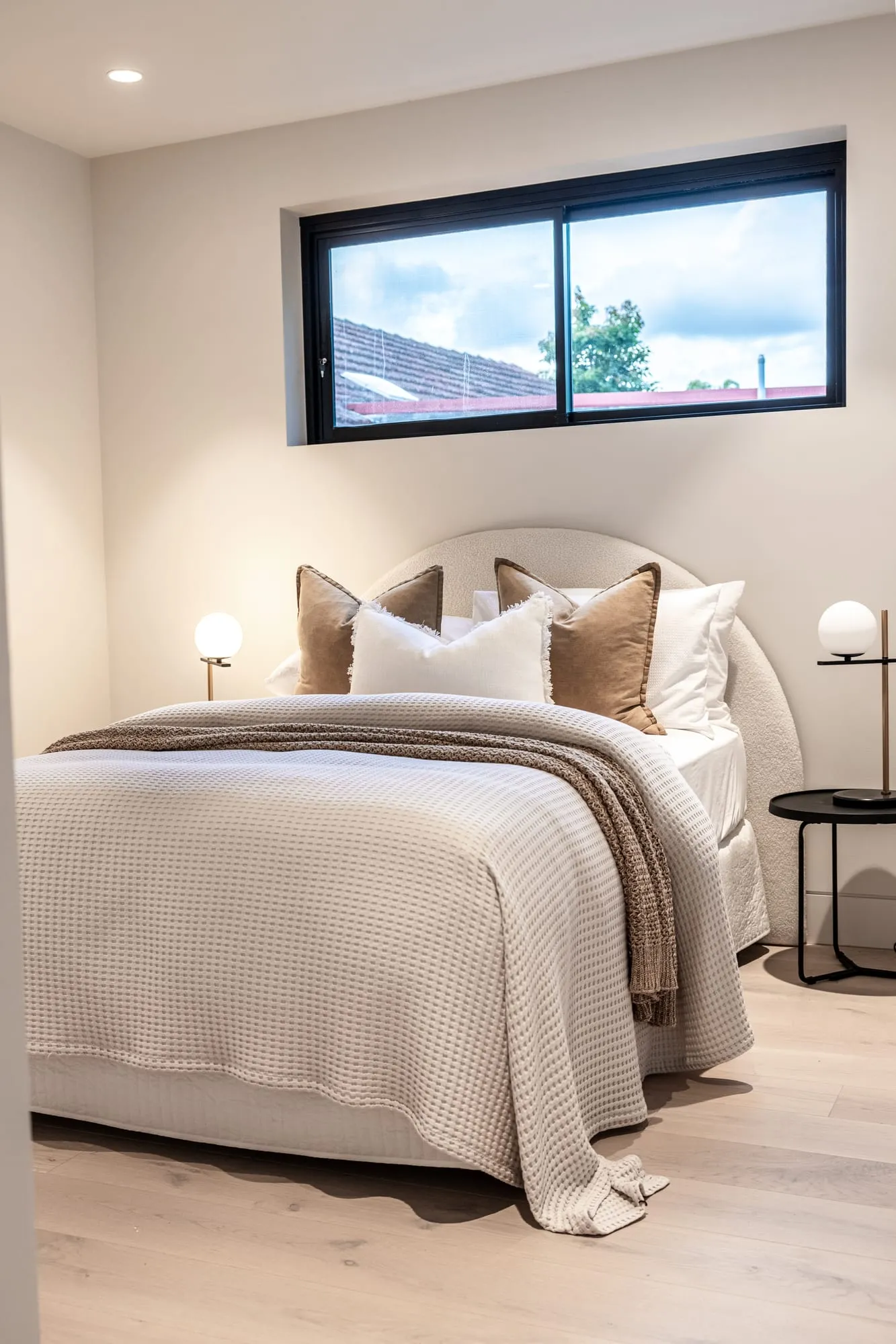 Bedroom with an upholstered bedhead and layered linen