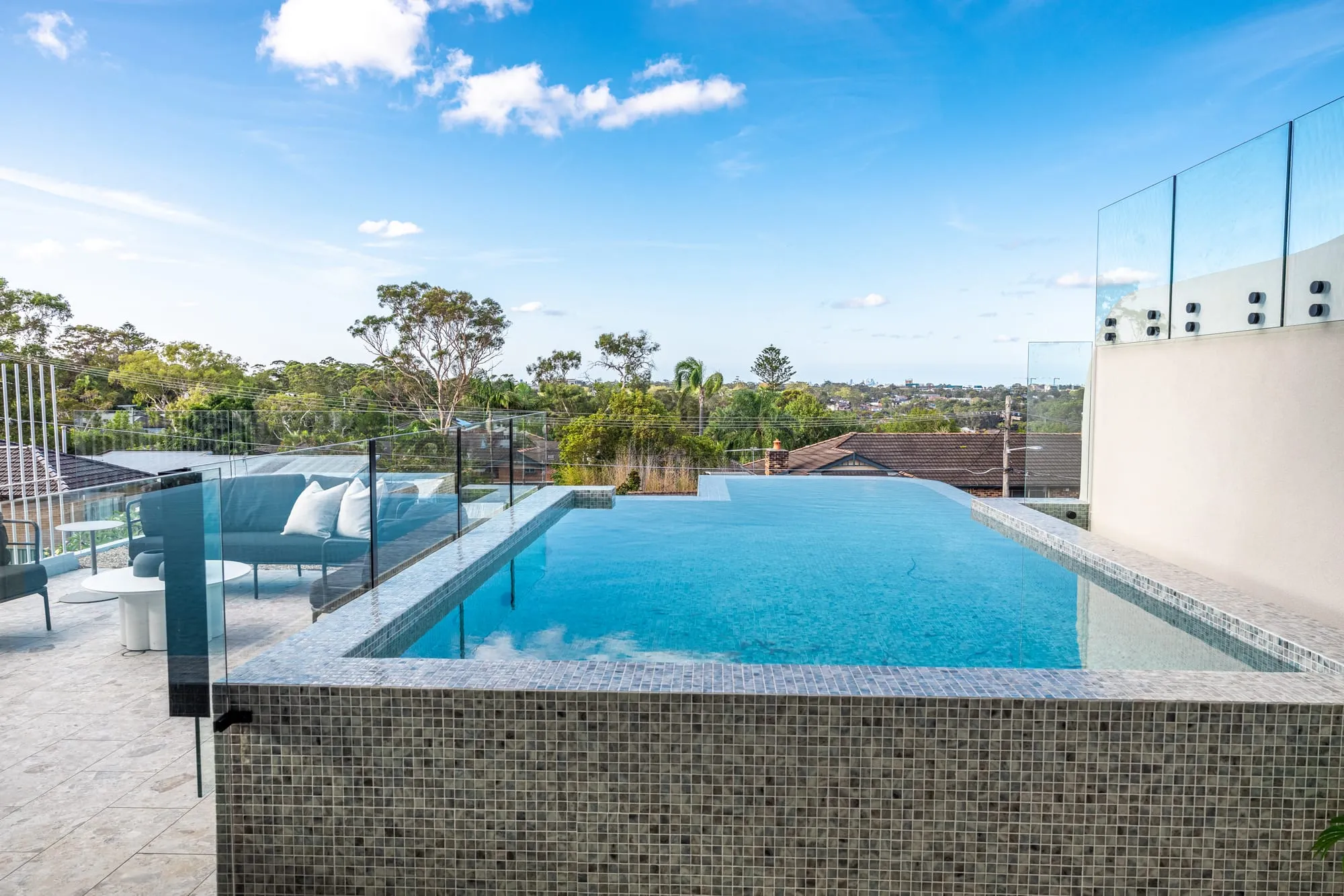 Infinity pool overlooking bushland and the district beyond
