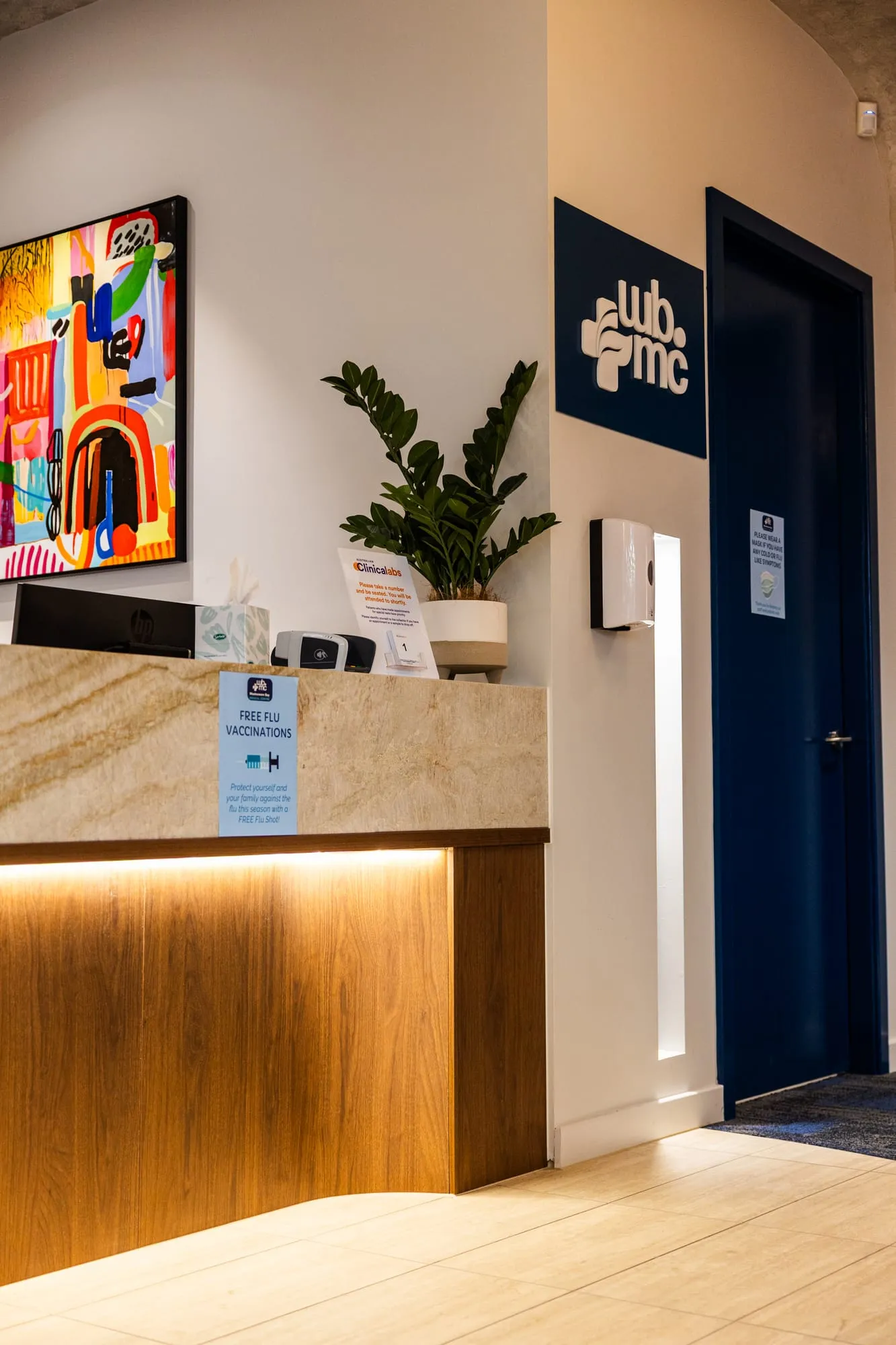 Entry and reception with feature artwork and timber joinery