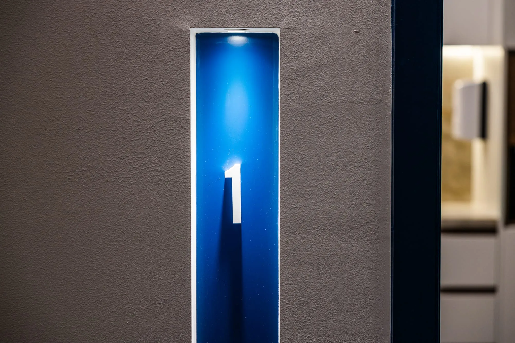 Backlit suite number and entry detail