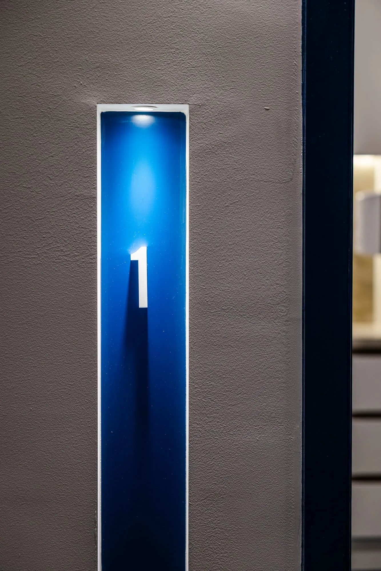 Backlit suite number marker for wayfinding