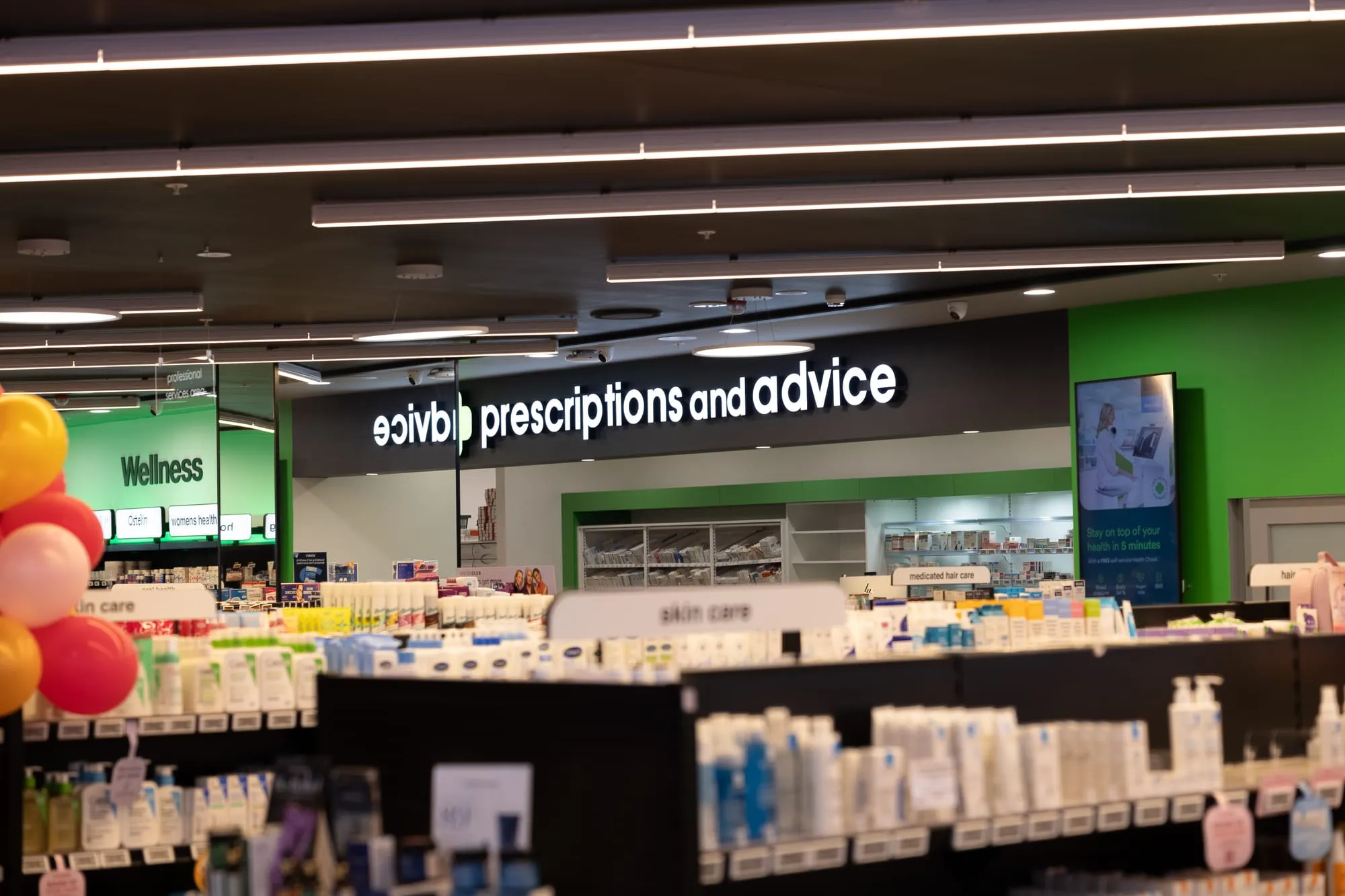 Backlit prescriptions and advice signage above the dispensary