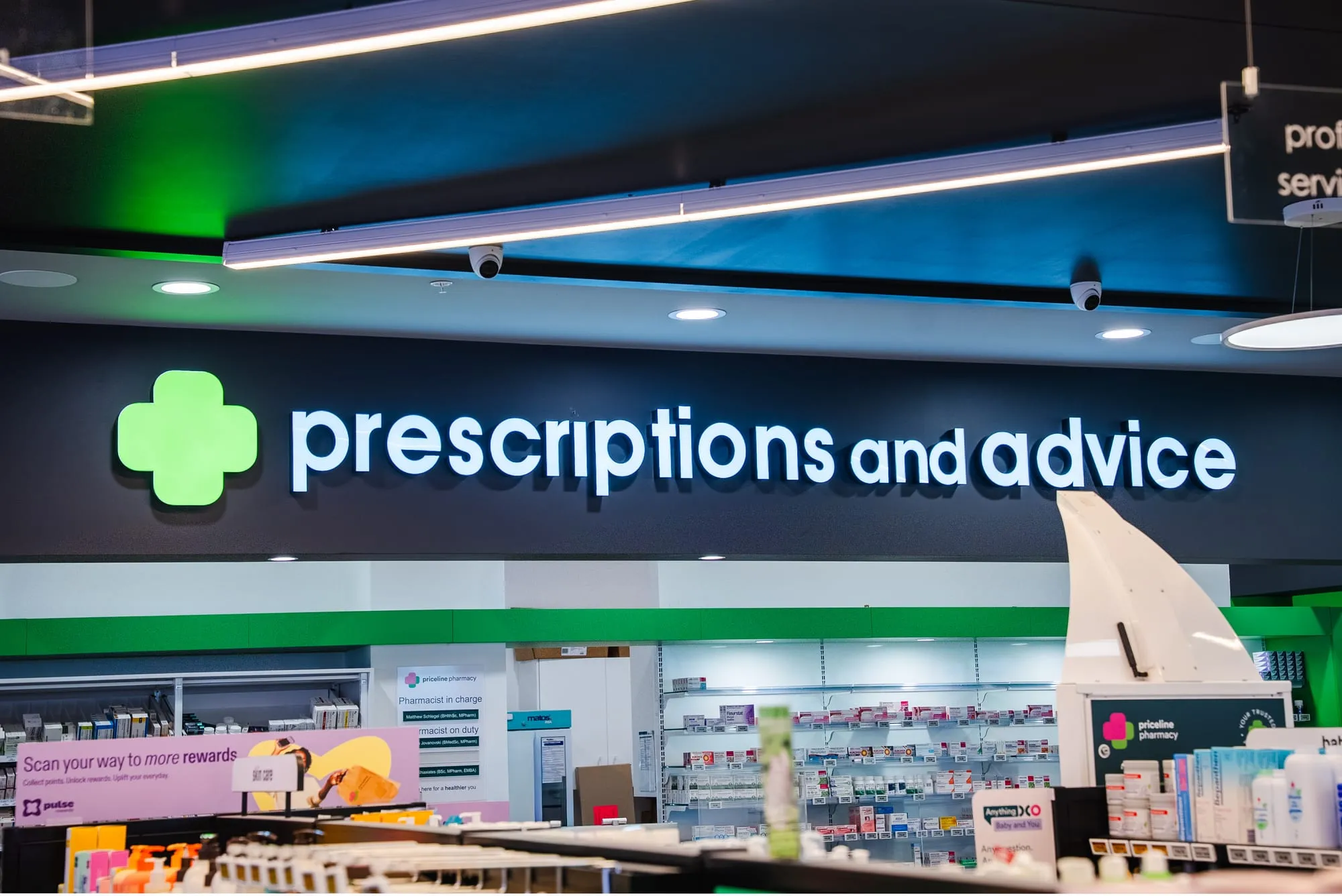 Prescriptions and advice dispensary with backlit signage