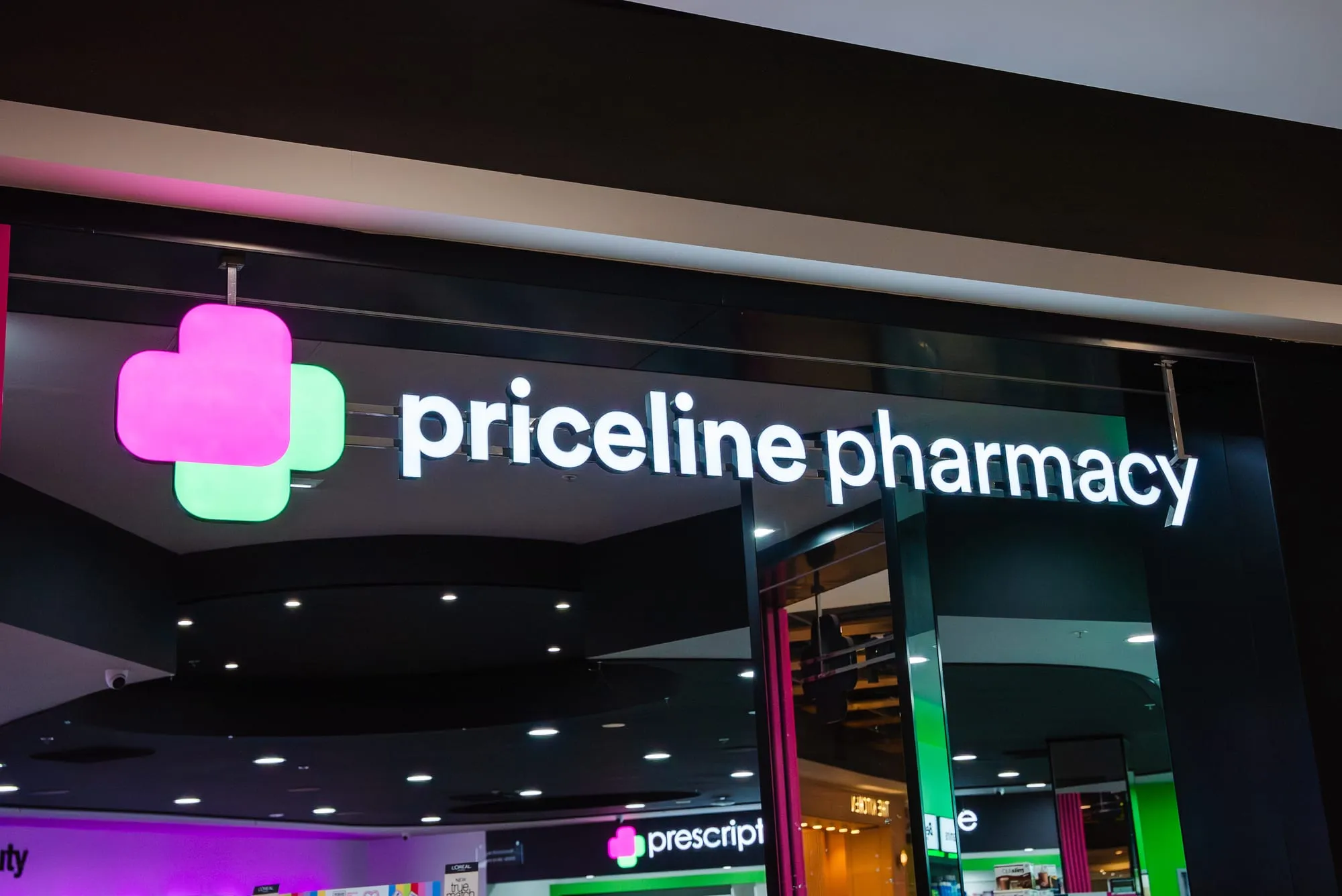 Illuminated Priceline Pharmacy signage above the shopfit