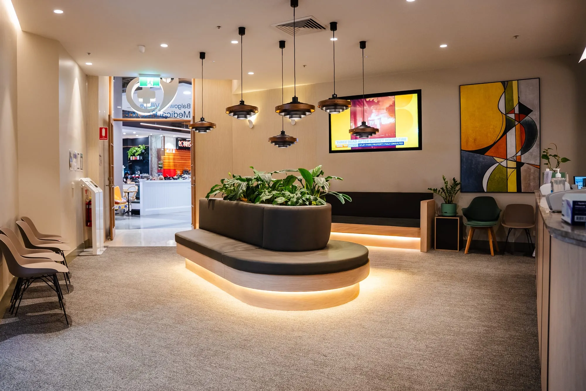 Warm reception area with feature pendant lighting and greenery
