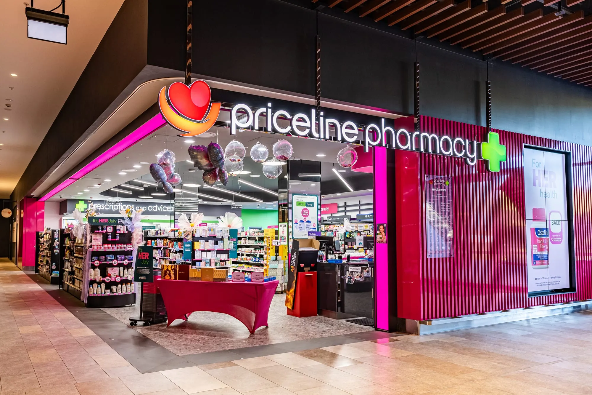 Illuminated Priceline Pharmacy shopfront at Woolooware